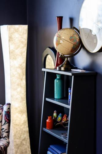 a book shelf with a globe on top of it at MI CASA- 4 Bd- Mega Playground in Willmar