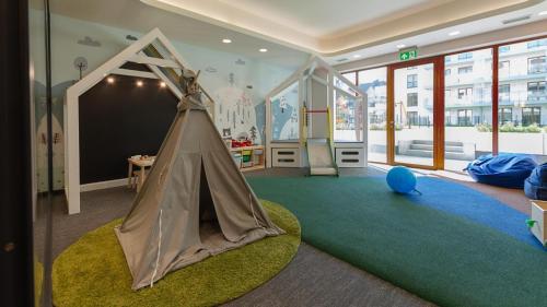 a room with a play room with a play tent at JHM Apart in Zakopane