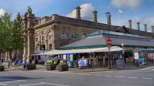 a large building with a market in front of it at The Accrington Haven in Accrington