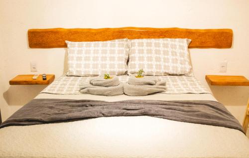 Ein Bett oder Betten in einem Zimmer der Unterkunft Vila Malie milagres