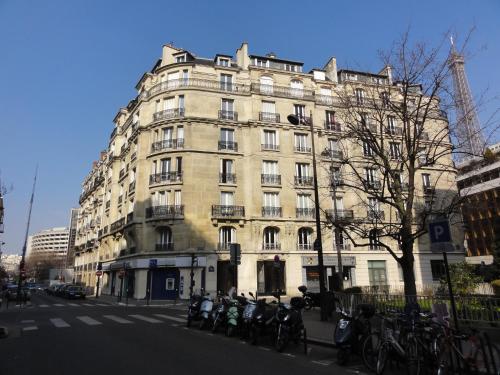 a large building with motorcycles parked in front of it at Relais12bis Bed & Breakfast By Eiffel Tower in Paris