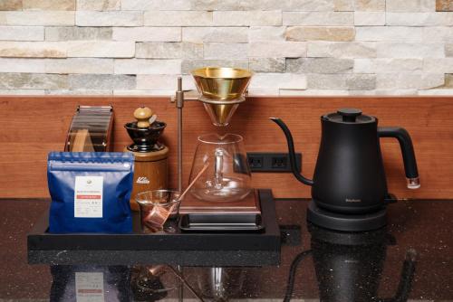 a table with a coffee maker and a blender at Seifutei in Inawashiro