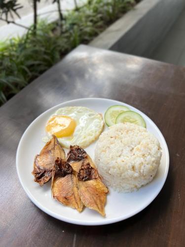a white plate of food with rice and vegetables at 1075 Dormitel in Cebu City