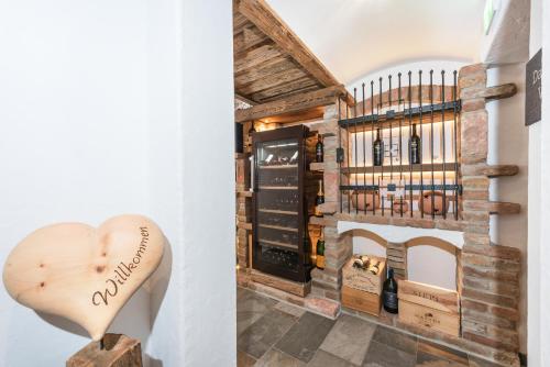 a room with a fireplace and a heart shaped wine cellar at Pension Restaurant Dorfalm in Leogang