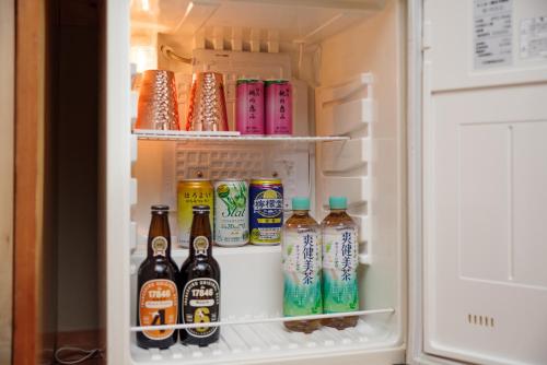 an open refrigerator filled with lots of drinks at Seifutei in Inawashiro
