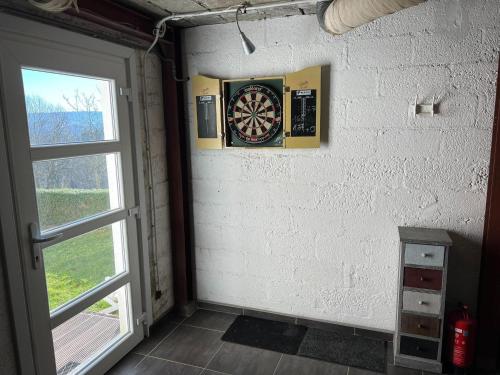 a dart board on a wall next to a door at Spacious Villa with Sauna in Érezée