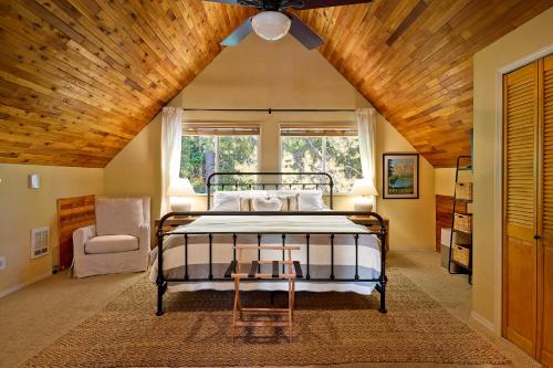 a bedroom with a bed and a wooden ceiling at Riverfront Chalet Near Skiing, Lakes, Mtns & Leavenworth in Leavenworth