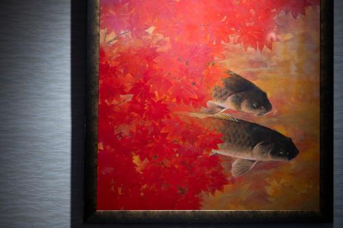 a painting of two fish in front of red flowers at Seifutei in Inawashiro