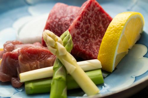 a plate of fruits and vegetables on a table at Seifutei in Inawashiro