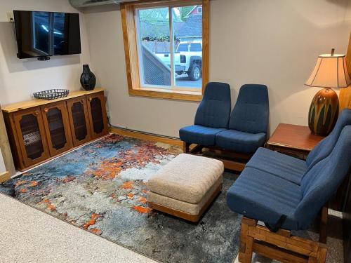 a living room with two chairs and a tv at MY FLAT! Industrial 3 Bd with outdoor space! in Willmar