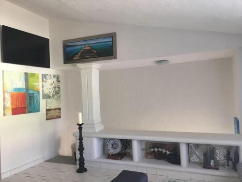 a living room with a fireplace with a tv on the wall at COZUMEL-1 Bed 1 Ba PARADISE in Cozumel