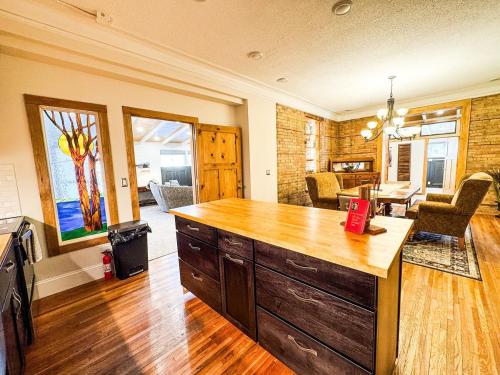 a kitchen with a large wooden island in a room at MY PLACE! Luxury 2 Bed with piano! in Willmar