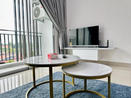 a living room with a table and a tv at Bayu Temiang - 5pax Quiet Home in Seremban