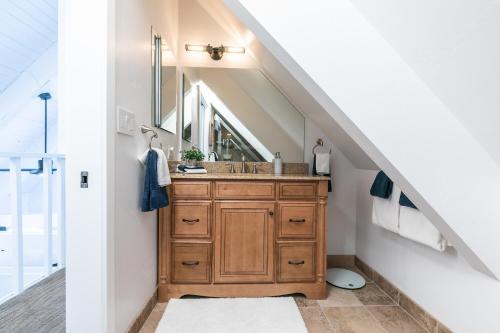 a bathroom with a sink and a mirror at Donner Gem by Tahoe Getaways - Beautifully Updated, Hot Tub, Pet Friendly in Truckee