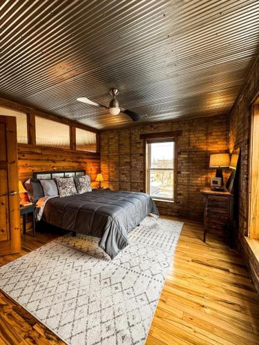 a bedroom with a bed and a brick wall at THE LOFT 3 level urban cabin with a HUGE patio! in Willmar