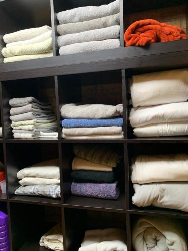a closet filled with lots of shirts and towels at THE LOFT 3 level urban cabin with a HUGE patio! in Willmar