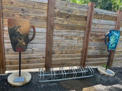 two sculptures of a coffee cup and a trophy at THE LOFT 3 level urban cabin with a HUGE patio! in Willmar