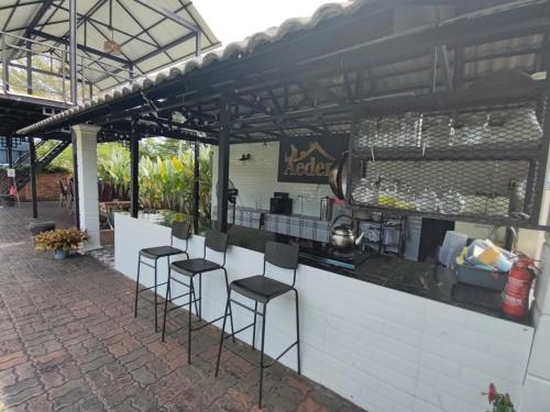 a bar with stools in front of a counter at Aeden Villa Roomstay & Homestay in Kuala Kangsar