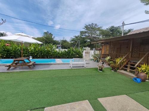 a backyard with a lawn and a pool at Aeden Villa Roomstay & Homestay in Kuala Kangsar