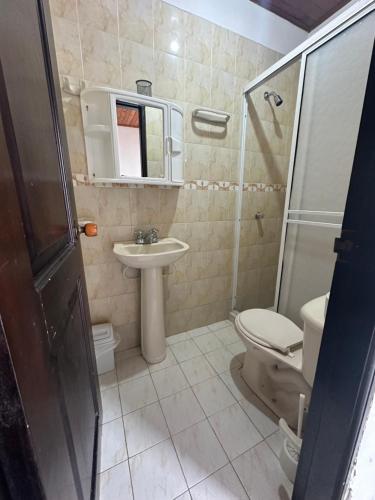 a bathroom with a sink and a toilet and a shower at Casa con tres dormitorios y garaje in Montería