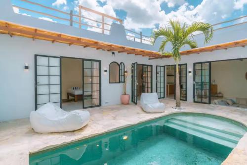 a villa with a swimming pool and a house at Villa Aurelia - 2 Bedrooms Rooftop Villa in Canggu in Canggu