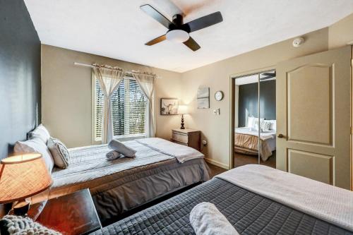 a bedroom with two beds and a ceiling fan at Poconos Paradise Lakeskihikewater Parkkids in Lake Harmony