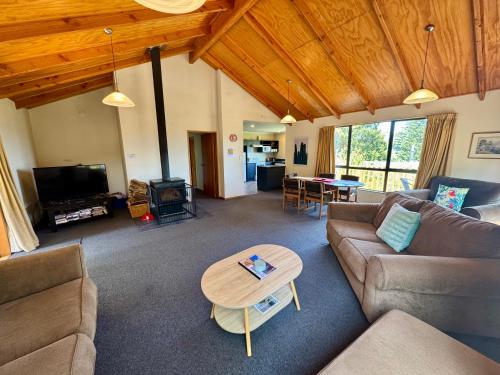 a living room with a couch and a table at 5 Alpine Avenue in Hanmer Springs