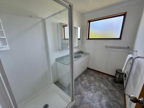 a bathroom with a shower and a sink at 5 Alpine Avenue in Hanmer Springs