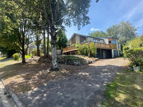 a house with a tree in front of it at 5 Alpine Avenue in Hanmer Springs