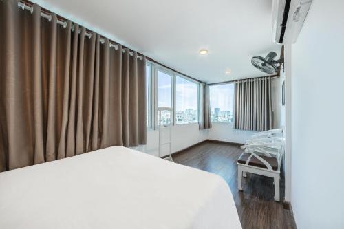 a hospital room with a bed and a chair at A25 Hotel - 185-187 Lò Đúc in Hanoi