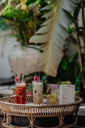 a tray with three cocktails on a table at La Bastide de Caro in Siem Reap