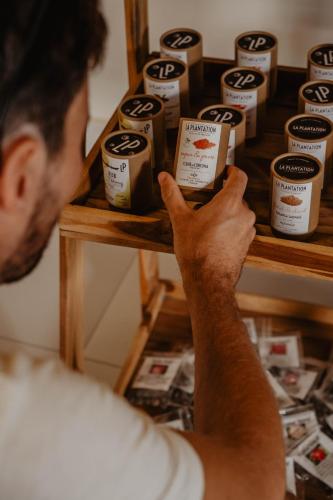 a man looking at a shelf of peanut butter jars at La Bastide de Caro in Siem Reap