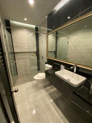 a bathroom with a sink and a toilet and a mirror at villa kamala regent 2 bedrooms in Kamala Beach