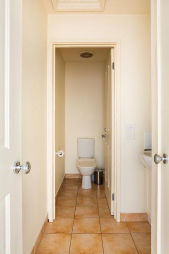 a bathroom with a toilet and a sink at Glorious 3-BRM Family House at Aspendale Beach in Aspendale