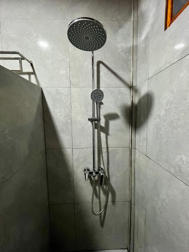 a shower with a shower head in a bathroom at Gokhon Guest House in Tuk Tuk