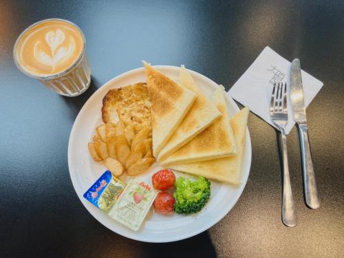 a plate of food with toast and chips and a cup of coffee at Dayin Youth Hostel - Old Town & People's Square& Rail Hub -Social Area -Bar -Café -Gym -Free Laundry Luggage Storage -24H Front Desk -English Service in Shanghai