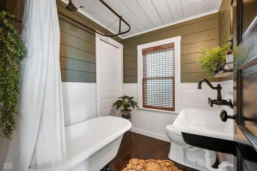 a bathroom with a tub and a toilet and a sink at Cozy & Scenic Lakeside Retreat in Leesburg