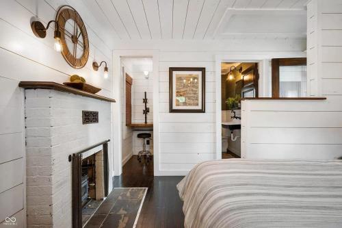 a white bedroom with a fireplace and a bed at Cozy & Scenic Lakeside Retreat in Leesburg