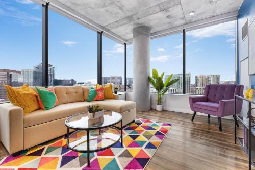a living room with a couch and large windows at The Urban Kaleidoscope Downtown Nashville in Nashville