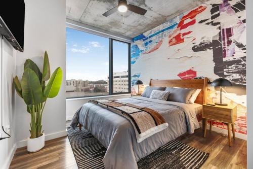 a bedroom with a large window and a bed at The Urban Kaleidoscope Downtown Nashville in Nashville