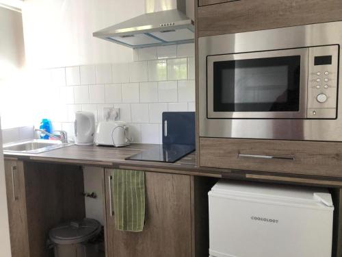 a kitchen with a counter top with a microwave at ASM 23 Lancaster Place in Leicester