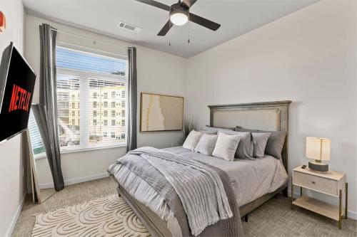 a bedroom with a bed and a ceiling fan at Pinnacle Heights 2Bdrm 3rd flr Near Walmart Amp Pool Fitness Center Yoga Studio Dog Spa in Rogers