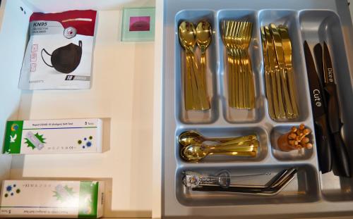 a tray with gold utensils in a refrigerator at Elite Escape Hawera in Hawera