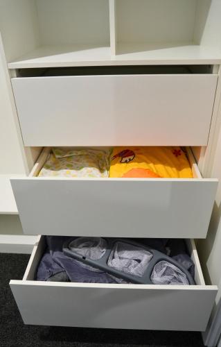 a drawer in a closet filled with shoes at Elite Escape Hawera in Hawera