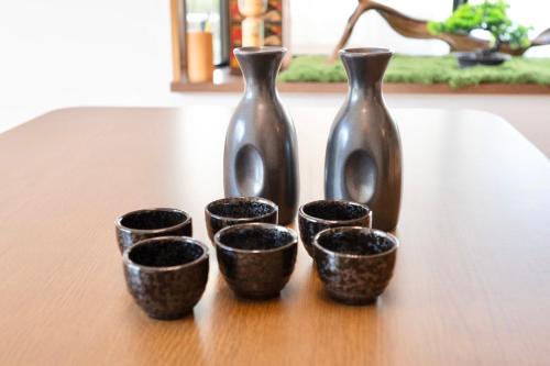 a group of three vases sitting on a table at たび宿Yumiashi in Sendai