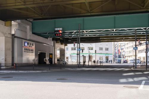 an empty street with a traffic light in a city at Locanda shin-Osaka in Osaka
