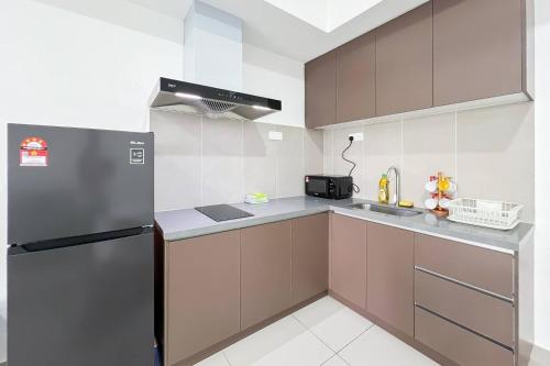 a kitchen with a refrigerator and a sink at Alinea Luxury Condominiums, Shah Alam - Smarthome in Shah Alam
