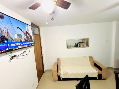 a bedroom with a bed and a flat screen tv at Comfortable House in Punta Hermosa