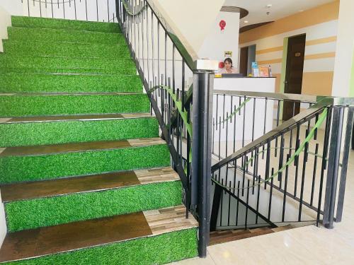 a staircase with green grass on it at Kayong's Inn in Dumaguete