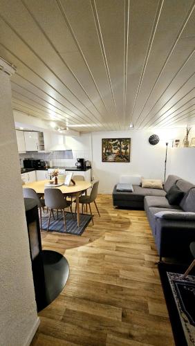a living room with a couch and a table at Central and Large cosey apartment in Stavanger